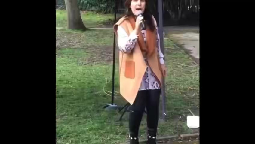Lindsey J Moore performing outdoors.