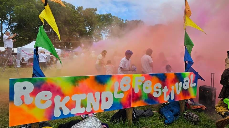 Colourful powder cloud rising over the ReKINDle Festival field.