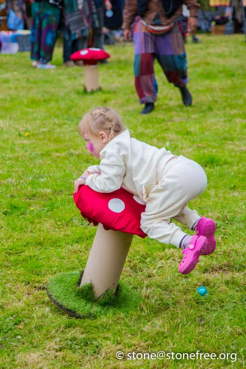 Child playing with colourful festival props.