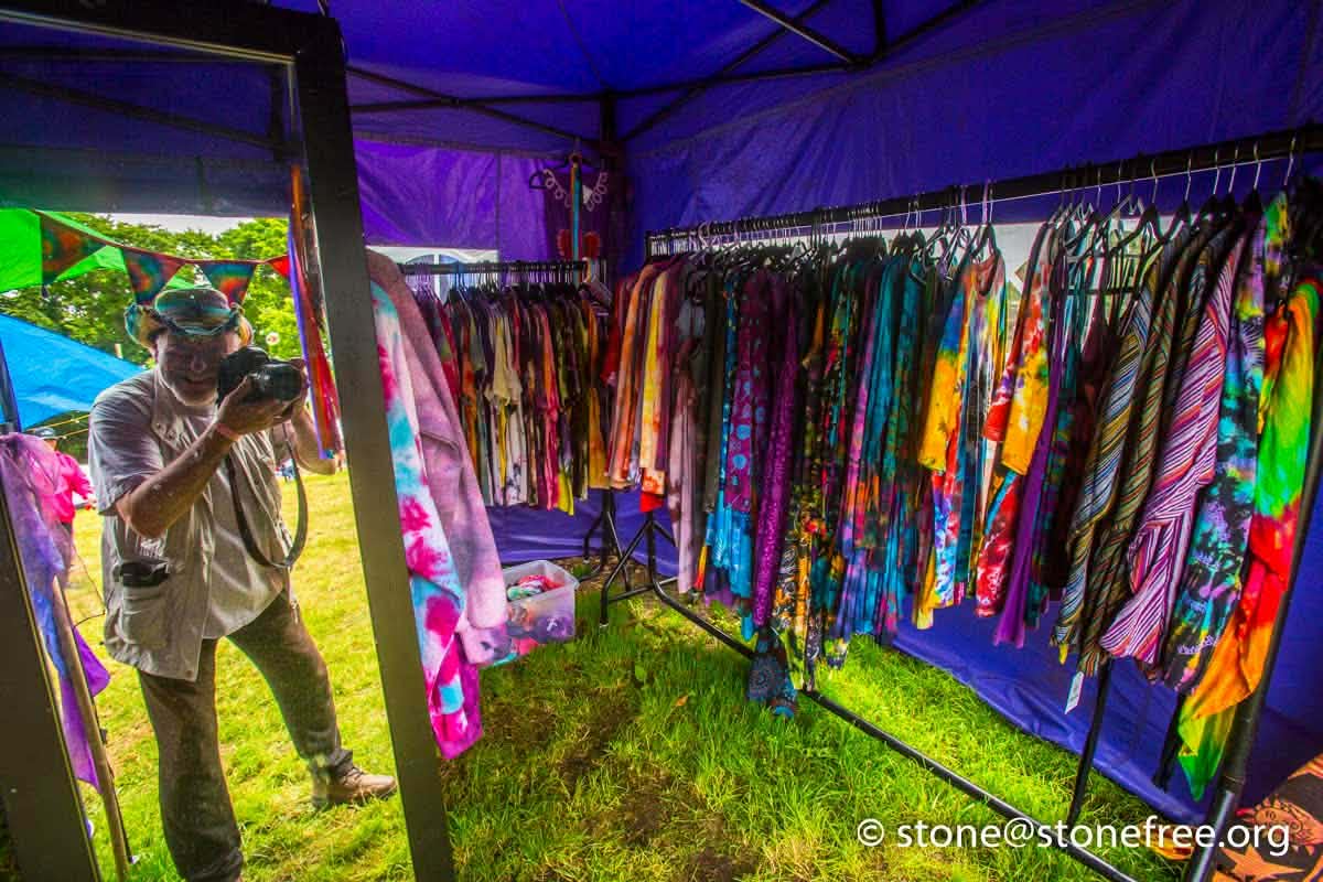 Colourful glow tent filled with bright hanging items.