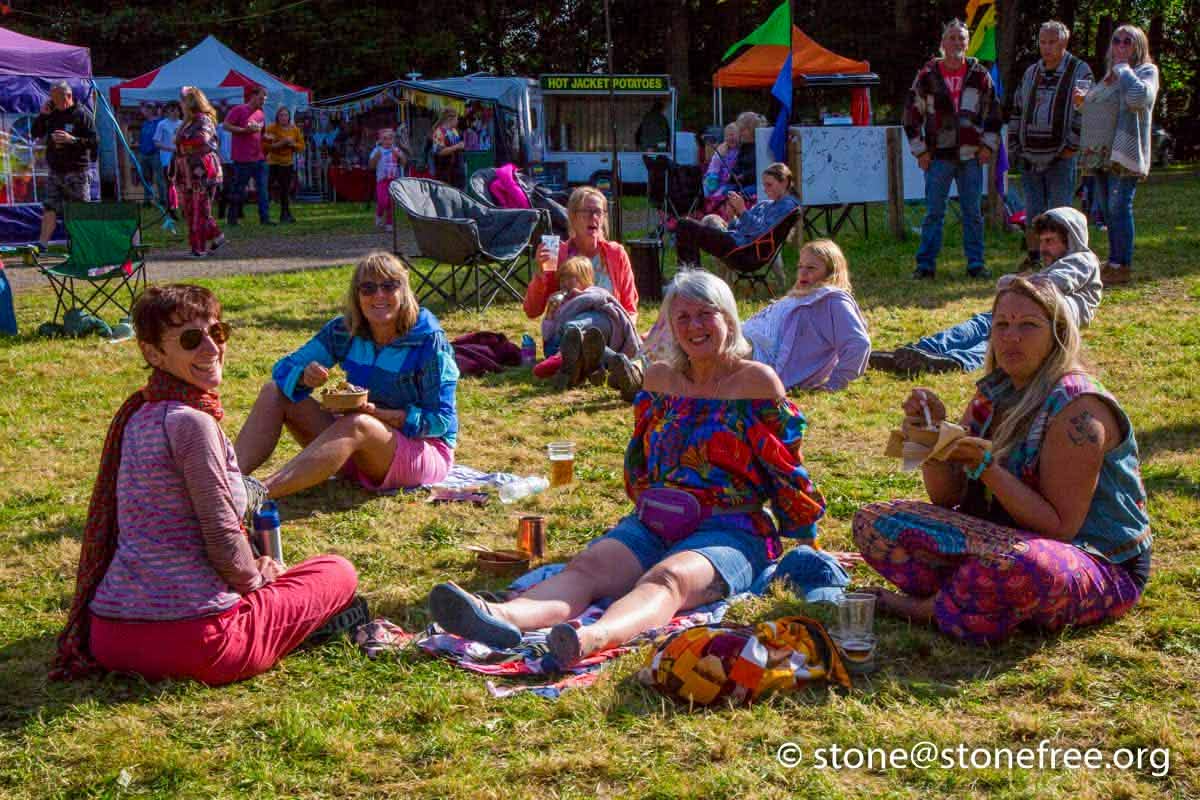People gathered on the grass for a relaxed festival session.