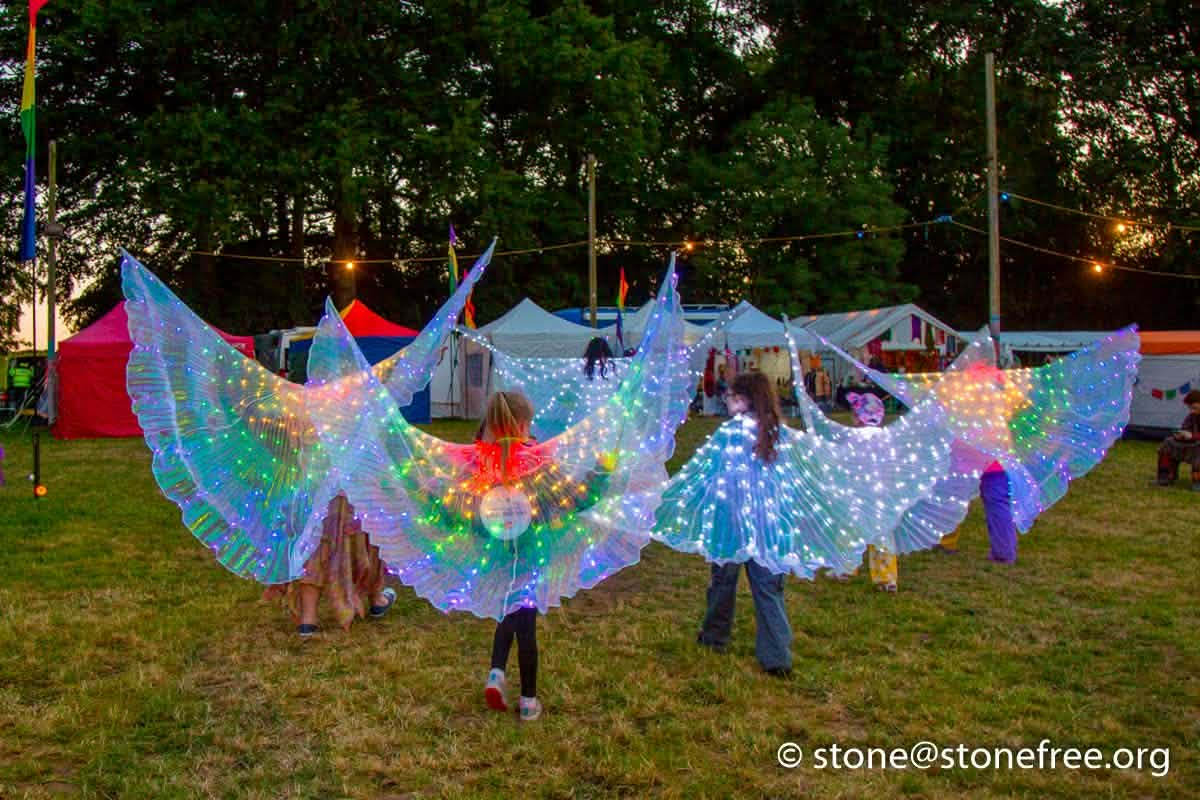 Colourful fabric banners carried across the festival field.