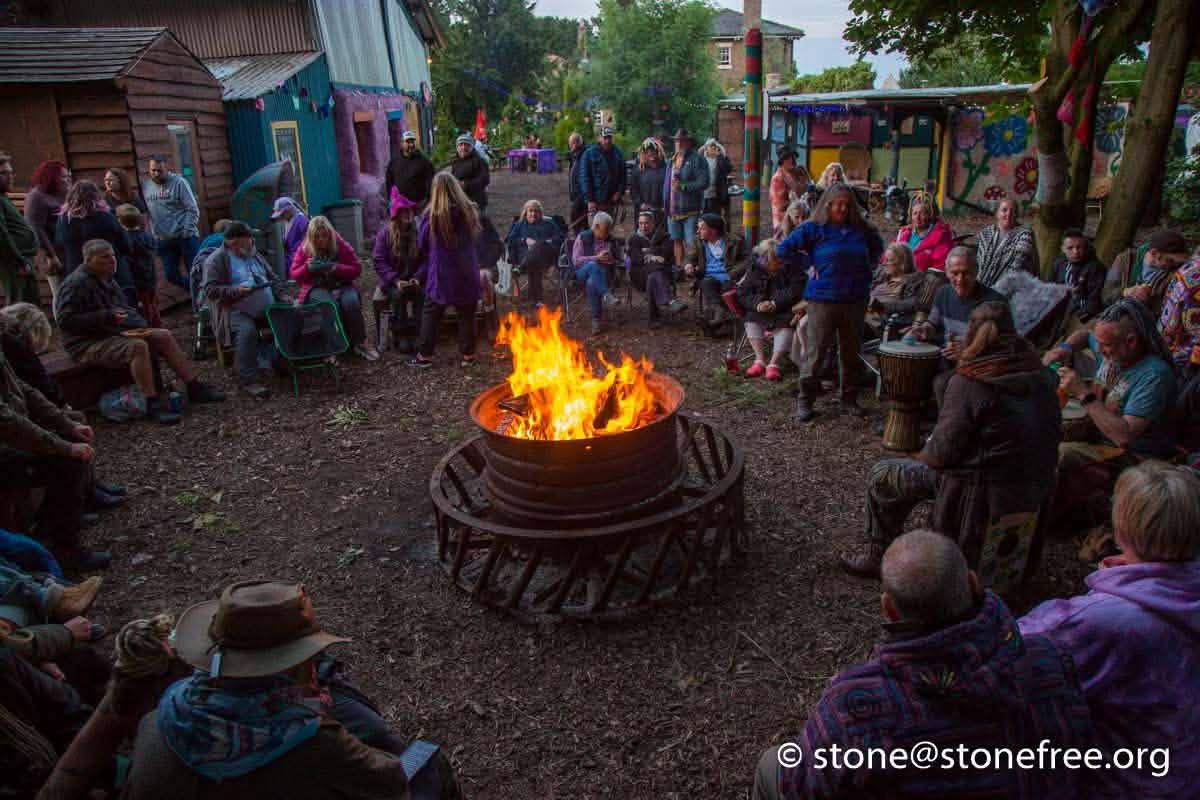 People gathered around a fire pit at ReKINDle Festival.