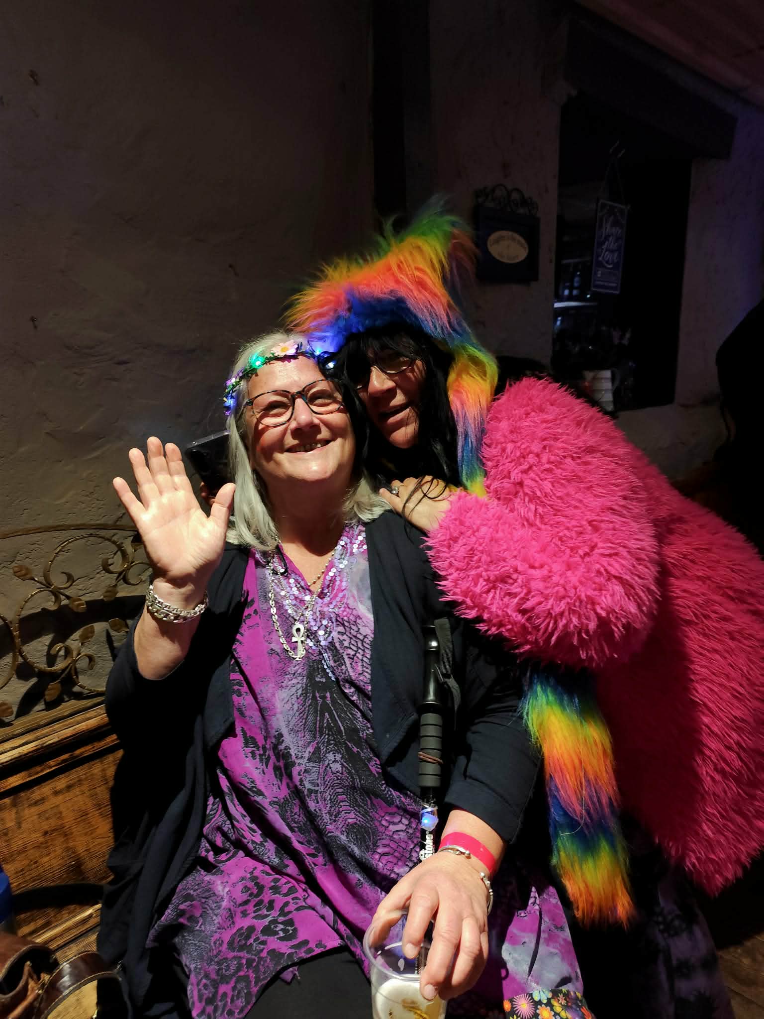 Colourful walkabout festival performer smiling at night.